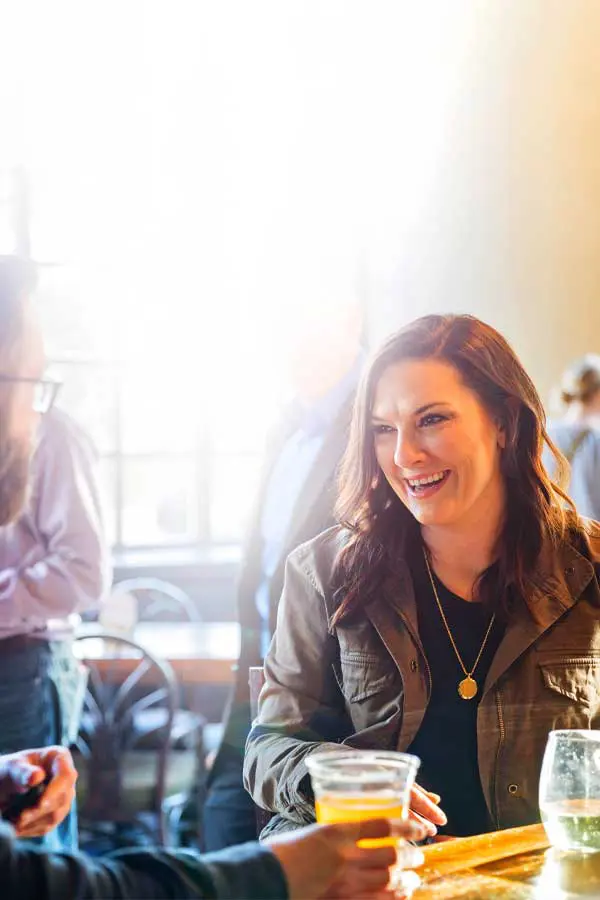 Male and female customers having drinks at bar