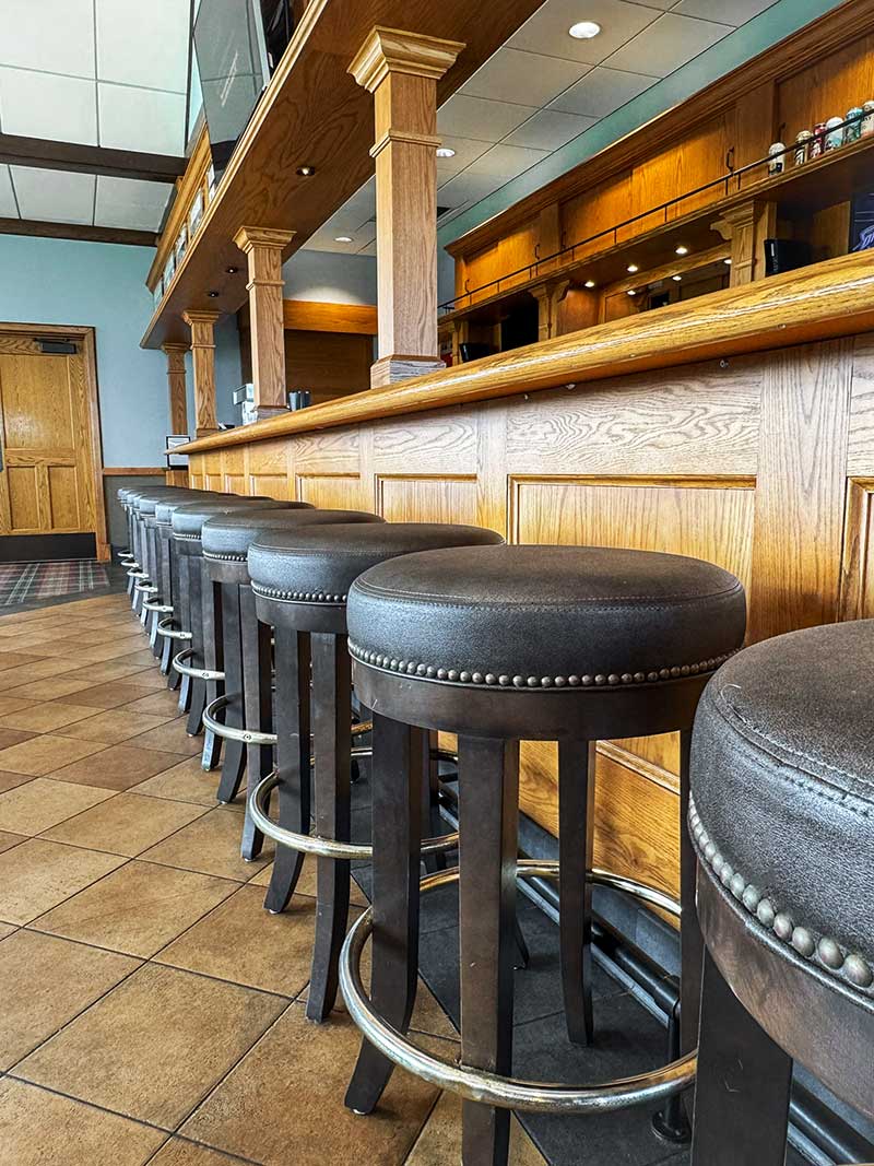 Stools lined up next to bar